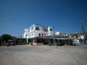 un grande edificio bianco in mezzo a una strada di Calypso Hotel a Lisso (Lipsoi)