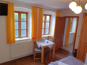 a dining room with a table and two windows at Altstadtcafé und Pension in Havelberg