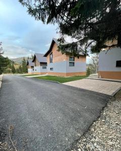 an empty road in front of a house at Woodland Resort Shkrel in Boge