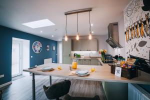 a kitchen with a table with two glasses on it at The Cosy Coo Shed in Forfar