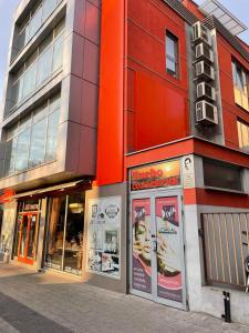 un edificio rojo con carteles en el costado. en Boutique Apartment, en Plovdiv