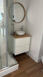 a bathroom with a sink and a glass shower at Studio face mer pieds dans l’eau in Saint-Hilaire-de-Riez
