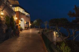 a building with lights on the side of a street at Hotel Punta Tragara in Capri