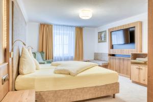 een hotelkamer met een bed en een televisie bij Hotel Alte Post in Sankt Anton am Arlberg