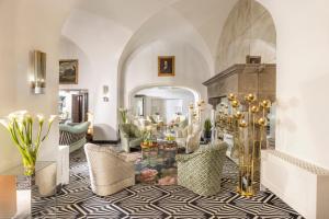 a living room with a table and chairs at Hotel Punta Tragara in Capri