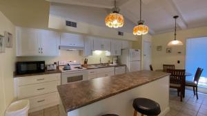 a kitchen with white cabinets and a counter top at SEA COTTAGE APARTMENT Duplex in Jekyll Island