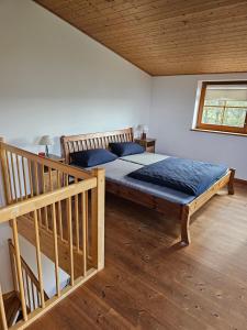 a bedroom with a large bed with blue pillows at Ferienwohnungen Das Finkhaus in Simonsberg