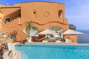 a resort with a swimming pool and a building at Hotel Punta Tragara in Capri