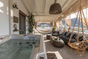 a bath tub in a room with a hammock at Black Velvet in Agkidia