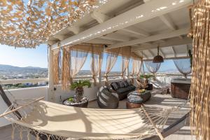 a hammock on the balcony of a house at Black Velvet in Agkidia