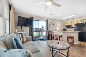 a living room with a couch and a table at St Thomas Square Villa 1211C Beach Bumz in Panama City Beach
