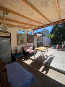 a patio with a table and a couch at ProyectoQva Glamping in Villa Ballester