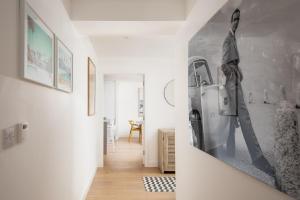 a living room with a refrigerator and a room with a hallway at 1 The Bay - Stunning contemporary flat on the Scottish coast in Coldingham