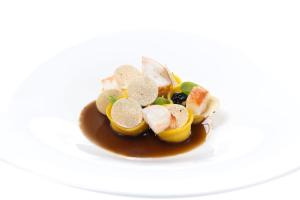 a plate of food with fruit and dipping sauce at Hotel Punta Tragara in Capri