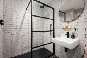 a bathroom with a shower and a sink and a mirror at 1 The Bay - Stunning contemporary flat on the Scottish coast in Coldingham +28 photos