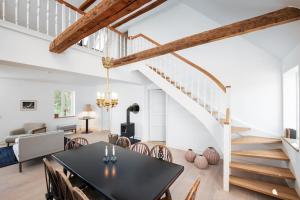 - une salle à manger et un salon avec une table et des chaises dans l'établissement Anemonehuset på Christianssæde, à Maribo