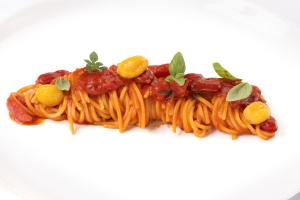 a plate of pasta with tomato sauce and vegetables at Hotel Punta Tragara in Capri