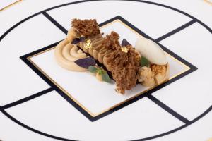 a plate of food with a piece of cake at Hotel Punta Tragara in Capri