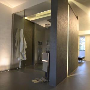 a bathroom with a mirror and a shower in it at luxury apartment in Pesaro