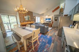 a kitchen and living room with a table and chairs at Flying Dutchman 1117 in Keystone