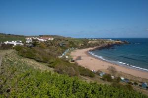 a view of a beach and the ocean at 1 The Bay - Stunning contemporary flat on the Scottish coast in Coldingham