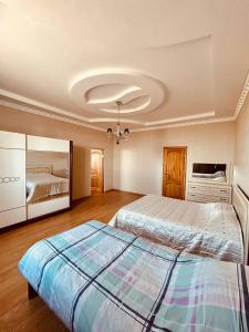 a large bedroom with two beds in it at Просторная 3 комнатная квартира in Atyrau