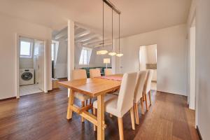 uma sala de jantar com uma mesa de madeira e cadeiras em City Apartment Bern, perfect located and spacious em Berna