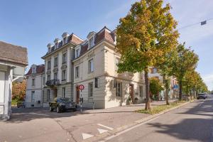 a large white building on the corner of a street at City Apartment Bern, perfect located and spacious in Bern