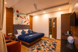 a bedroom with a bed and a tv in it at Shalom Backpackers Mussoorie in Mussoorie