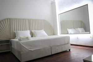A bed or beds in a room at Mega Hostal Santa Cruz