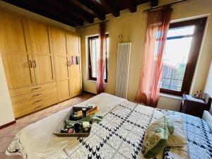 a bedroom with a bed with a tray on it at Residenza dei Mille in Mantova