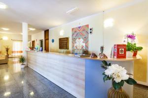 a lobby of a hospital with a reception counter at Hotel Petri Marini in Aglientu
