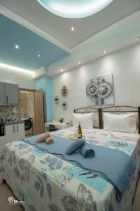 a bedroom with a large bed with a blue blanket at 'The Aqua'House Project In Athens in Athens
