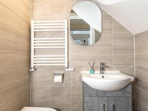 a bathroom with a sink and a mirror at Pass the Keys Bright and Airy 3BR New Flat near Central London in London