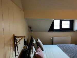 a bedroom with a bed and a window at Good night Leuven -Self check-in in Leuven