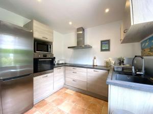 a kitchen with a sink and a stove top oven at Maison 3* rénovée, proche plage et sentier des douaniers, 4 pers, WIFI, parking, jardin, BBQ - FR-1-368-156 in Perros-Guirec