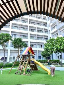 a playground in front of a large building at Taguig 1 Bedroom with balcony Grace Residences Near Bgc in Manila