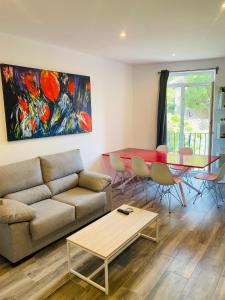 a living room with a couch and a table and a painting at Casas 349h Alicante Centre Second Floor in Alicante