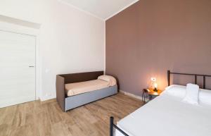 a small bedroom with two beds and a window at Relais Borbonico Apartment in Naples