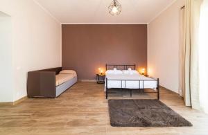 a bedroom with a bed and a couch at Relais Borbonico Apartment in Naples