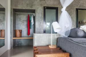 a bedroom with a bed and a table with a lamp at Deep Dream Chalet in Hinkong