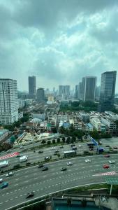 a large parking lot with cars in a city at Backpackers Cozy Apartment KL Sentral in Kuala Lumpur