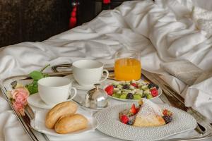a tray of breakfast food on a bed at Hotel Punta Tragara in Capri