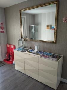 a bathroom vanity with a mirror and a sink at Anchorage Guest House - Also 1 room available with Hot Tub in Balloch