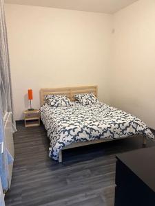 um quarto com uma cama e uma mesa com um candeeiro em Appartement 3 Chambres em Champigny-sur-Marne