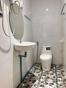 a bathroom with a sink and a toilet at Vang Vieng Global Hostel in Vang Vieng