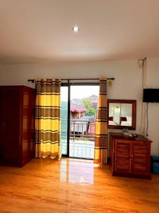 an empty living room with a sliding glass door at Vang Vieng Global Hostel in Vang Vieng
