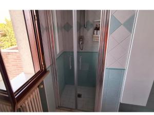 a shower with a glass door in a bathroom at Olga & Giò - Vicino al Centro di Cesena in Cesena