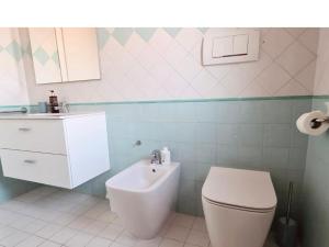 a bathroom with a white toilet and a sink at Olga & Giò - Vicino al Centro di Cesena in Cesena