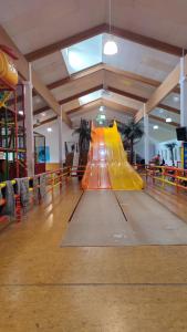 a slide in a gym with an orange slide at Stressless aktivCARD Bayerischer Wald inklusive in Sankt Englmar
